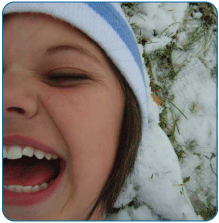 Girl Laughing in Snow